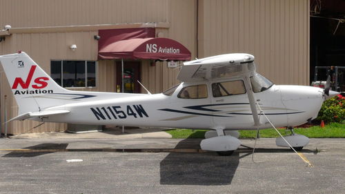 Side view of airplane sign on street in city