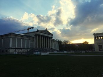 Buildings in city against sky at sunset