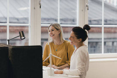 Smiling businesswomen working at desk in office