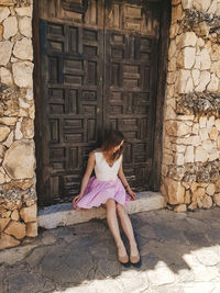 Woman sitting outside building