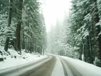 Road passing through snow covered landscape