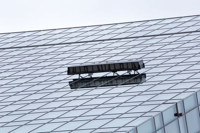 Low angle view of sign board on glass building