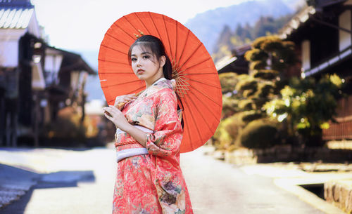 Beautiful girl wearing traditional japanese kimono in tsumago juku at nagano, japan.