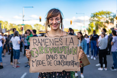 Portrait of smiling young woman standing with text