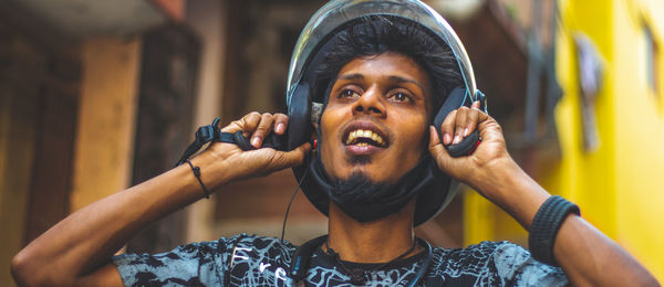 Protrait of a smiling guy wearing his helmet.