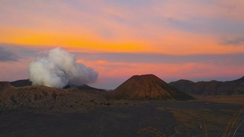 Panoramic view of volcanic landscape against sky during sunset