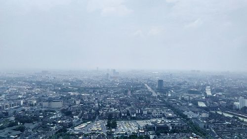 Aerial view of cityscape against sky