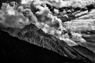 Scenic view of mountains against cloudy sky