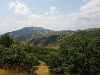 Countryside landscape against mountain range