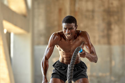 Portrait of young man exercising in gym