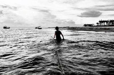 Man on sea against sky