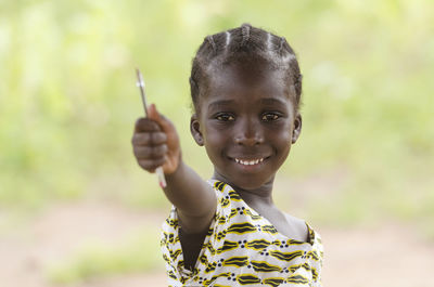 Portrait of smiling girl holding outdoors