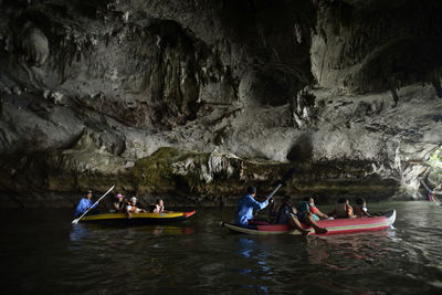 People kayaking through cave