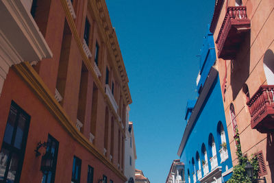 Low angle view of buildings against blue sky