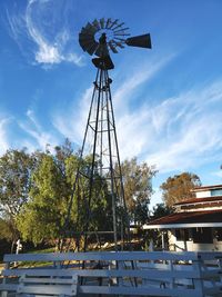 Low angle view of traditional windmill against sky