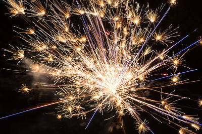 Low angle view of firework display at night