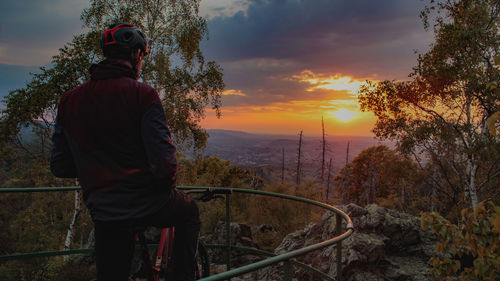 Rear view of man looking at sunset