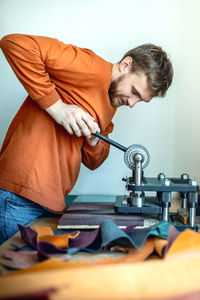 Midsection of man working in workshop