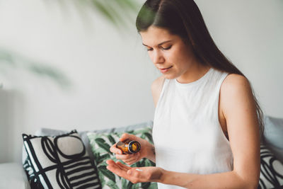 Young woman eating food at home