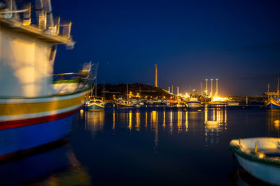 Boats moored at harbor