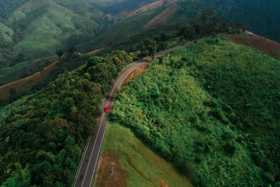 Aerial view of road amidst green landscape