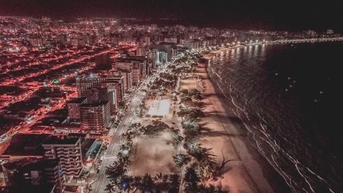 High angle view of city lit up at night