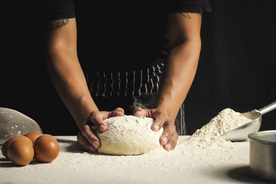 Midsection of man preparing food in kitchen