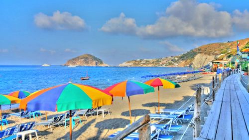 Scenic view of beach against cloudy sky