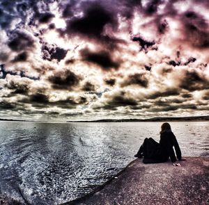 Rear view of people looking at sea