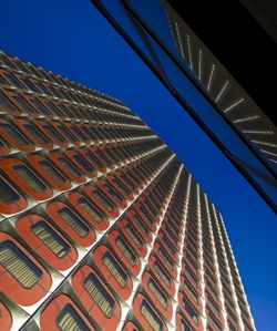 Low angle view of illuminated building against clear blue sky