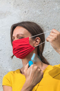 Close-up woman using hand fan