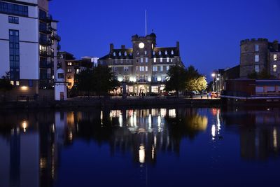 Reflection of illuminated buildings in lake at night