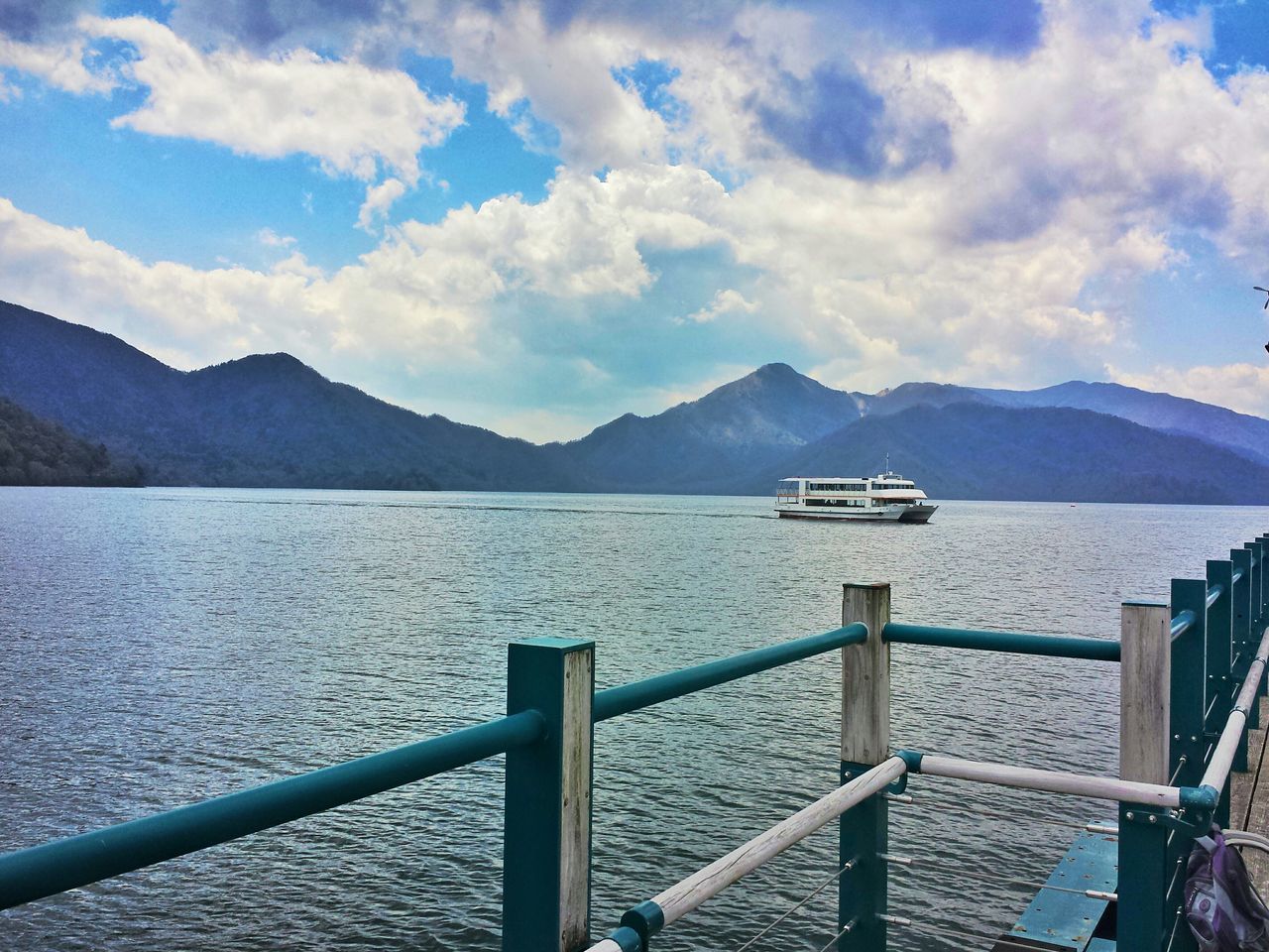 mountain, water, mountain range, sky, scenics, sea, tranquil scene, tranquility, nautical vessel, beauty in nature, nature, transportation, lake, rippled, cloud - sky, railing, boat, pier, idyllic, mode of transport