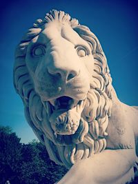 Low angle view of statue against blue sky