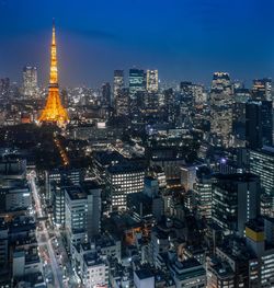 Aerial view of illuminated city buildings at dusk