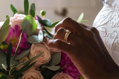 Close-up of hand holding flowers