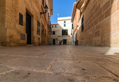 Empty alley amidst buildings in city