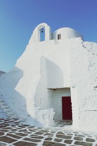 Exterior of white church against clear blue sky