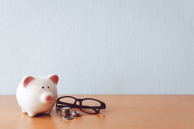 Close-up of white toy on table against wall