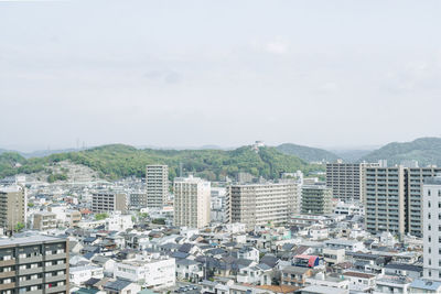 High angle view of buildings in city against sky