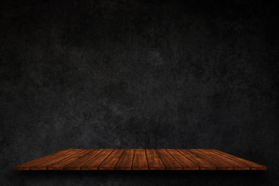 Wooden table against sky at night