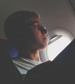 Low angle view of mature woman looking away in airplane