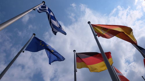 Low angle view of flag flags against sky