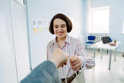 Meal delivery services, express office food lunch delivery. young smiling business woman working at