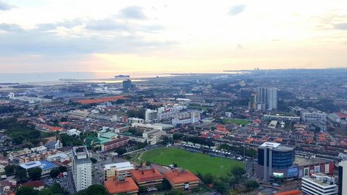 High angle view of city against cloudy sky