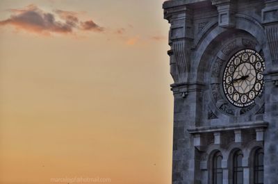 Low angle view of clock tower against sky during sunset