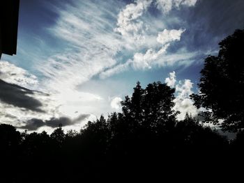 Low angle view of silhouette trees against sky