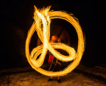 Fire dancer making peace sign during an event