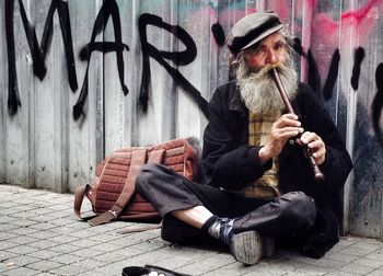 Full length of woman sitting on bench