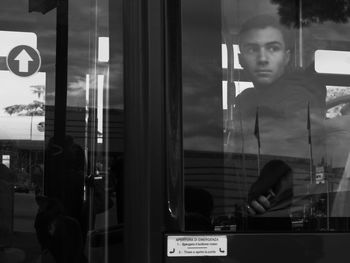 Portrait of man seen through glass window